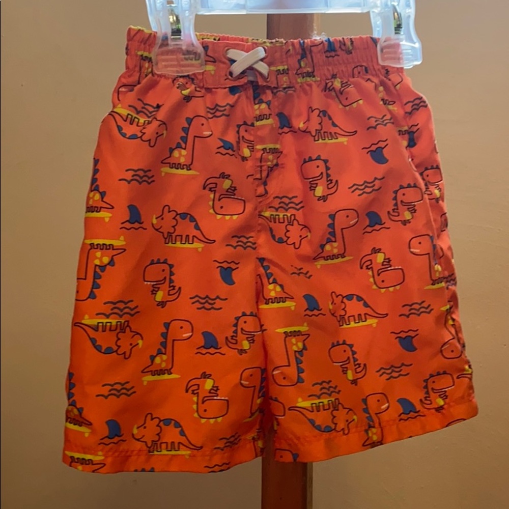 Orange and blue dinosaur toddler swim trunks